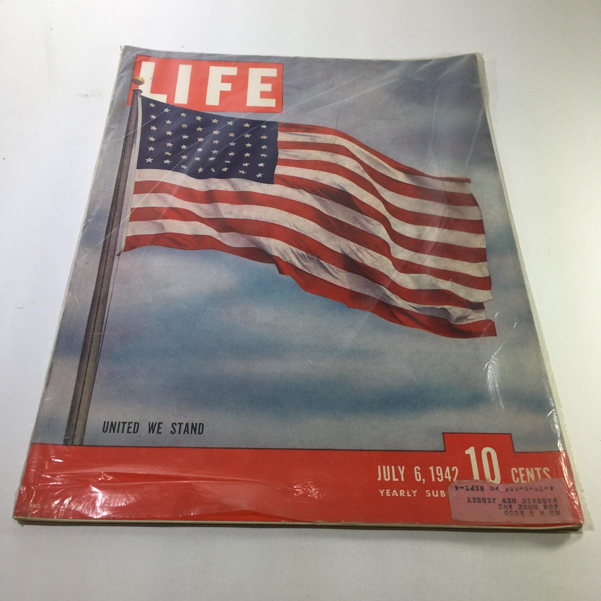 Cover of Life Magazine, July 6, 1942 - United We Stand, featuring a waving American flag against a blue sky background, highlighting a pivotal moment in World War II history.