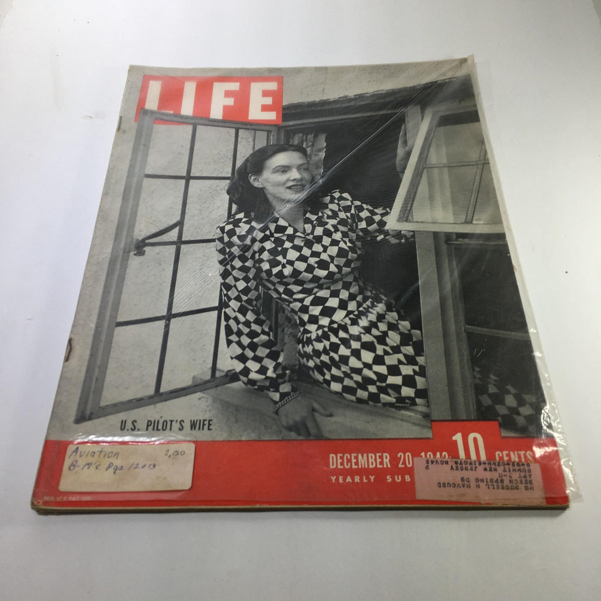 Vintage Life Magazine cover from December 20, 1943, featuring a U.S. pilot's wife. The cover showcases a woman in a striking black and white checkered dress, symbolizing the emotional impact of World War II on families. This collectible magazine highlights a significant era in American history.
