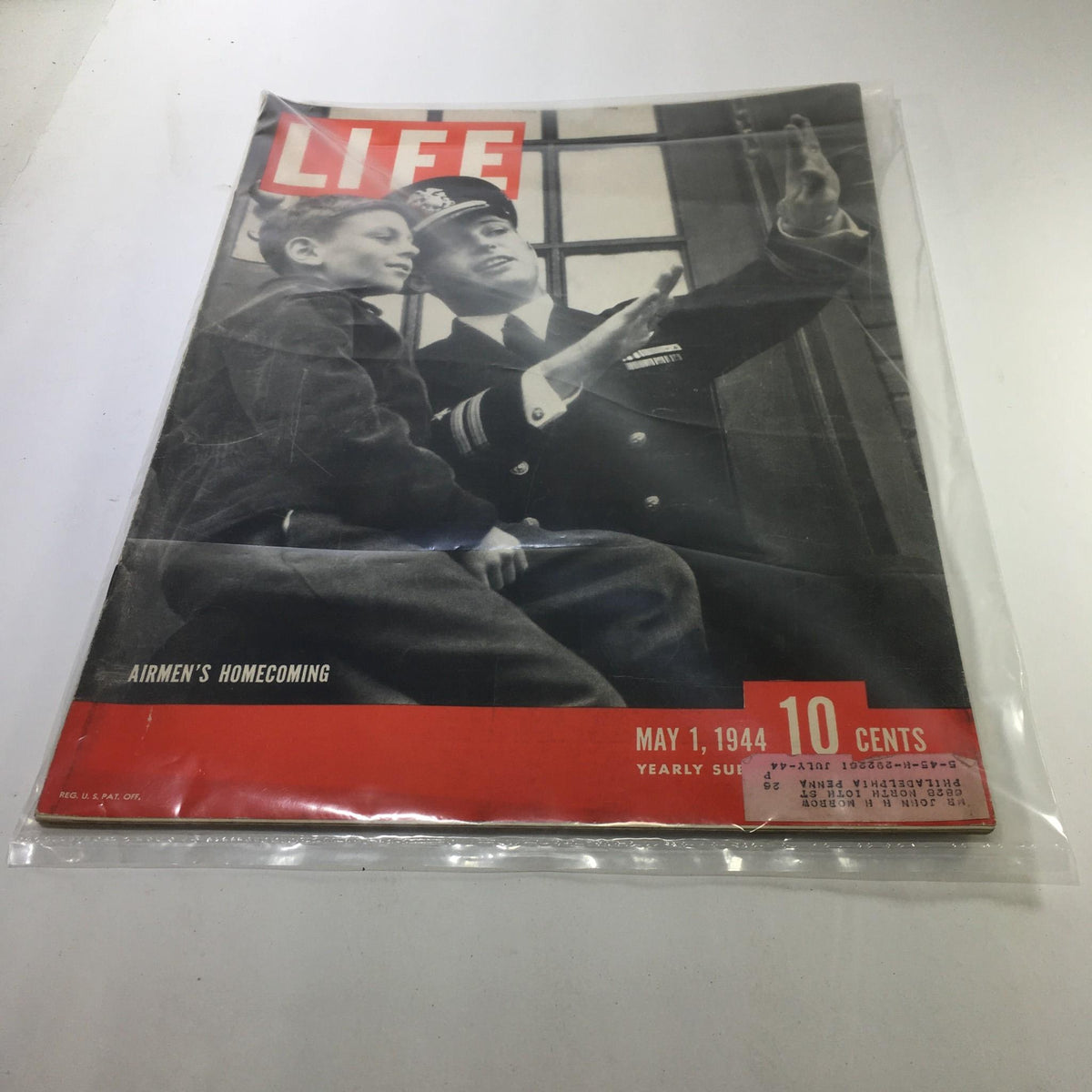 Cover of Life Magazine dated May 1, 1944, featuring the title 'Airmen's Homecoming'. The image shows a joyful reunion between a child and a naval officer, symbolizing the emotional returning of soldiers during World War II.