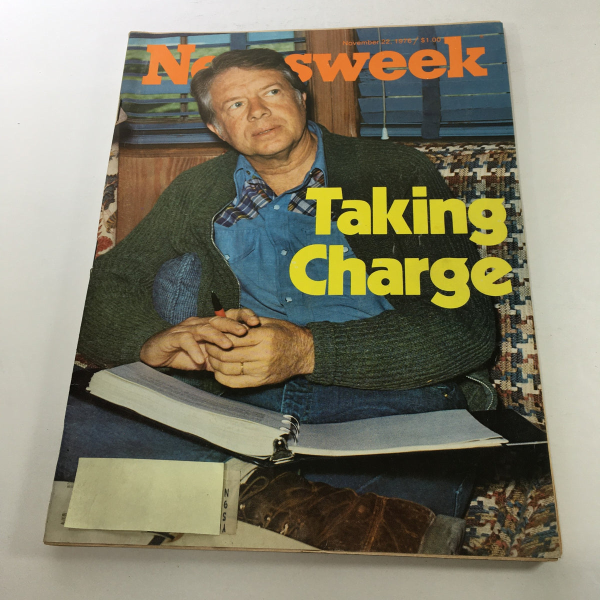 Cover of Newsweek Magazine from November 22, 1976, featuring the title 'Taking Charge: Jimmy Carter,' depicting Jimmy Carter in casual attire, engaged in thoughtful contemplation with a notebook in front of him.