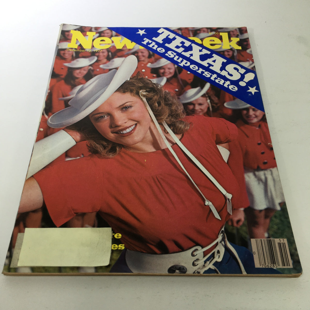 Cover of Newsweek Magazine from December 12, 1977, featuring the title 'TEXAS: The Superstate'. The cover showcases a smiling woman wearing a cowboy hat and a red outfit, surrounded by women in similar attire in the background, reflecting the vibrant culture of Texas during that era.
