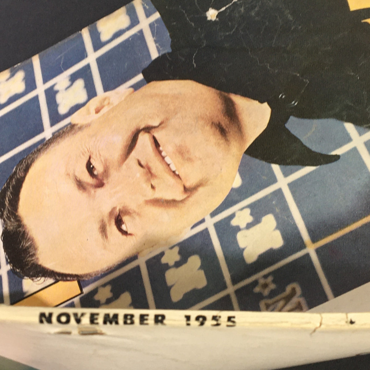 Close-up of VTG Sport Magazine November 1955 front cover showing the date and Eddie Erdelatz smiling, highlighting its vintage condition and historical significance.