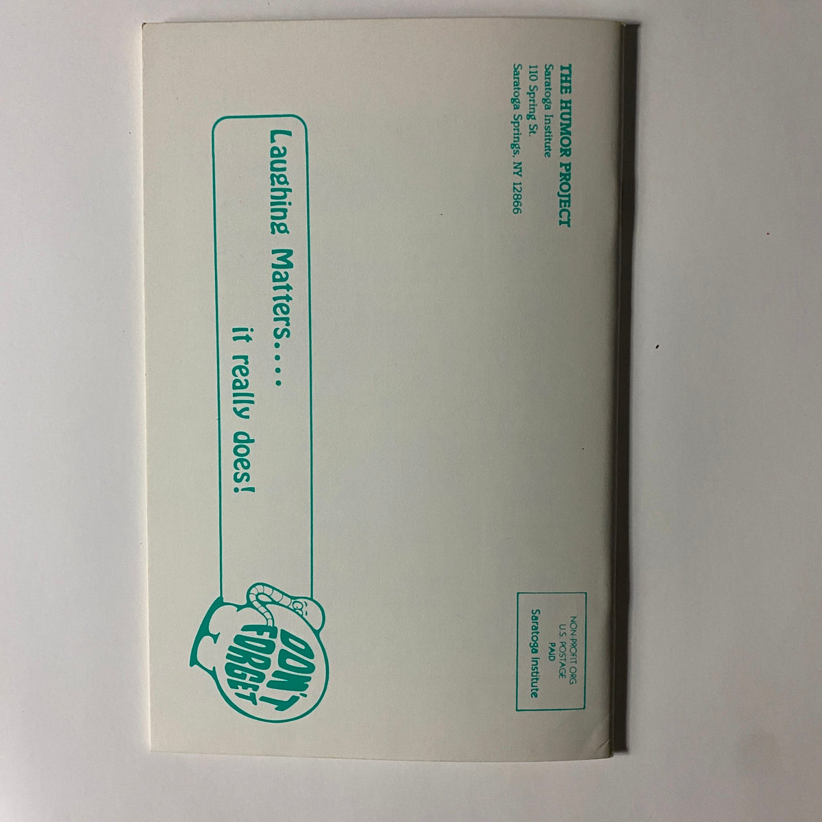 Envelope for 'Laughing Matters Volume 2 Number 4' featuring a humorous graphic and the phrase 'Don't Forget' emphasizing the importance of laughter in life.