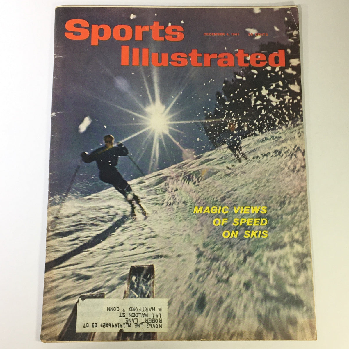 Cover of Sports Illustrated Magazine dated December 4, 1961, featuring an action-packed image of skiing with the title 'Magic Views of Speed on Skis.' This issue highlights Gene Tunney and coverage of the Giants and Packers, making it a significant collectible for vintage magazine enthusiasts.