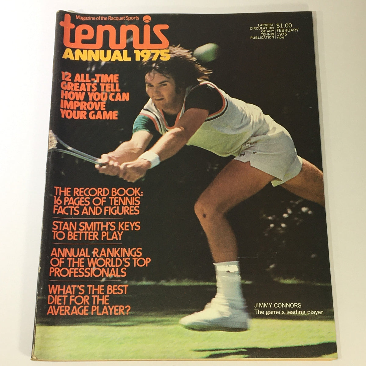 Cover of the VTG Tennis Magazine, February 1975, featuring tennis players Jimmy Connors and Stan Smith. The magazine includes highlights like 12 all-time greats sharing game improvement tips and annual rankings of tennis professionals, showcasing the rich history and culture of 1970s tennis.