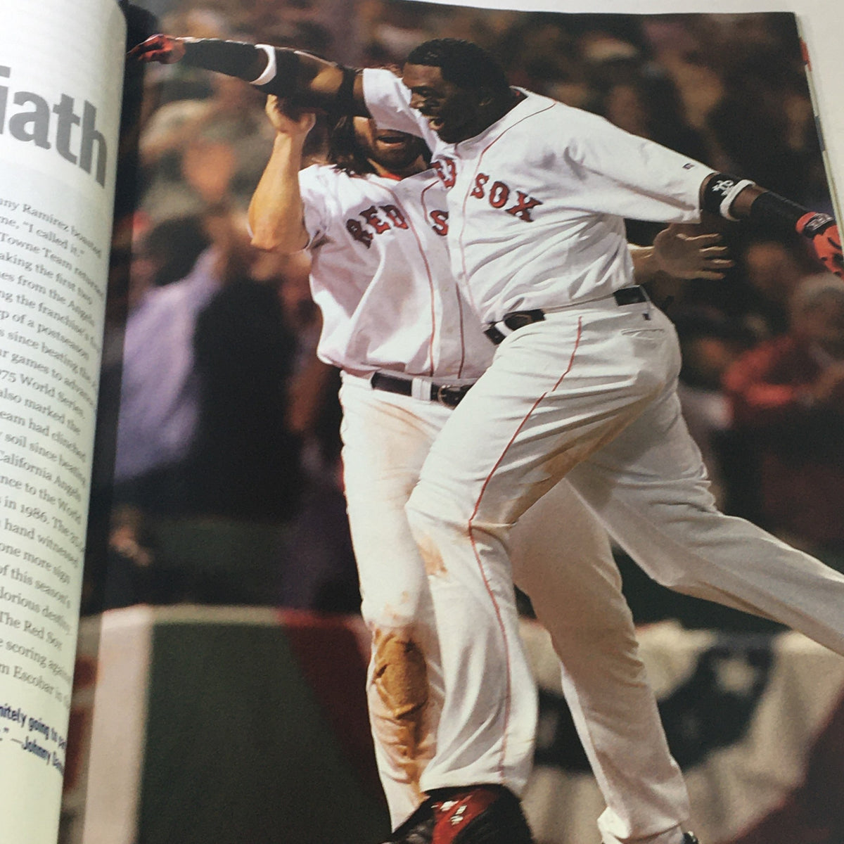 Action shot from Street & Smith's Presents 2004 World Champion Boston Red Sox magazine depicting players celebrating a victory, emphasizing the excitement of the championship.