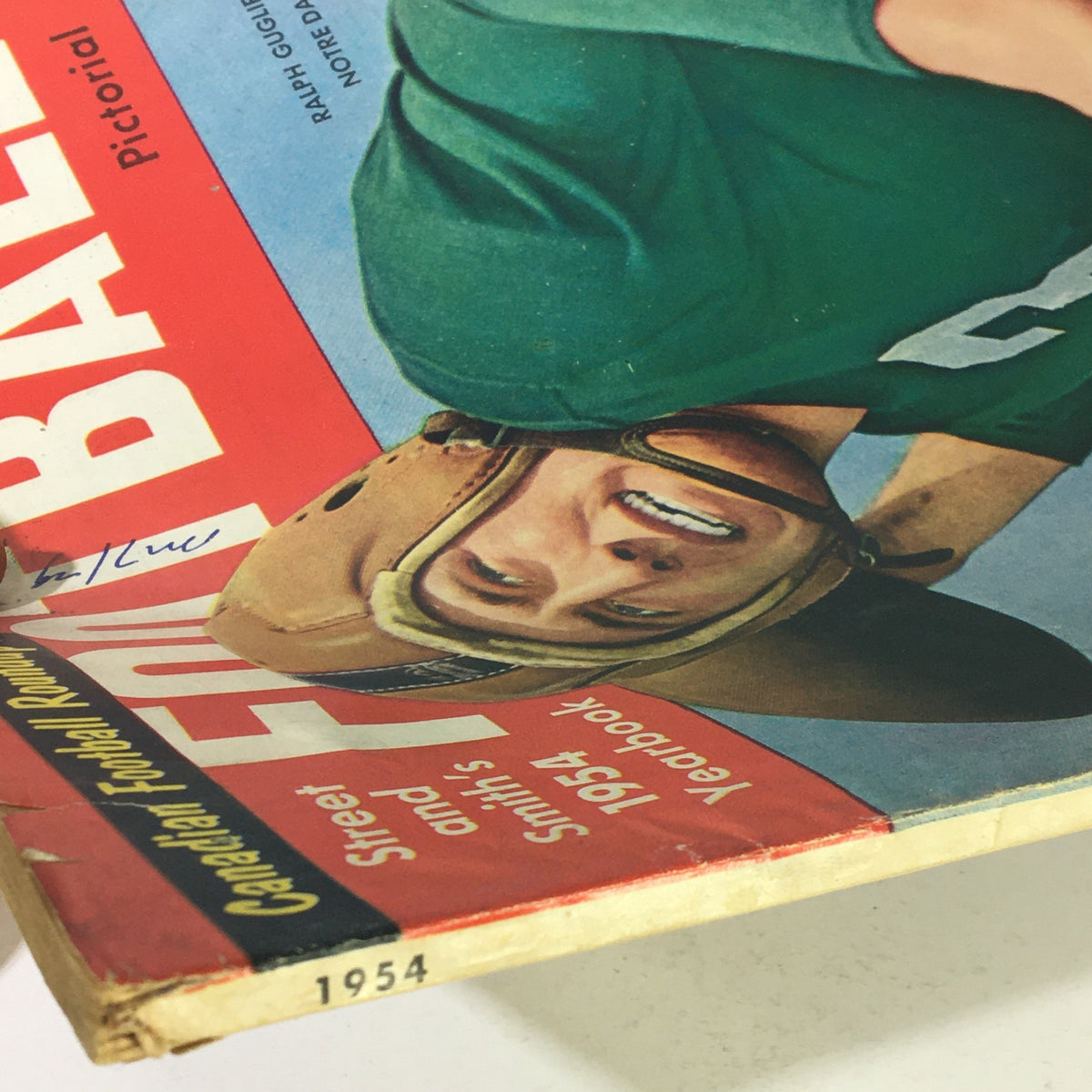 Close-up of VTG Street & Smith's 1954 Football Yearbook cover showing Ralph Guglielmi from Notre Dame, with visible signs of wear and unique vintage graphics.