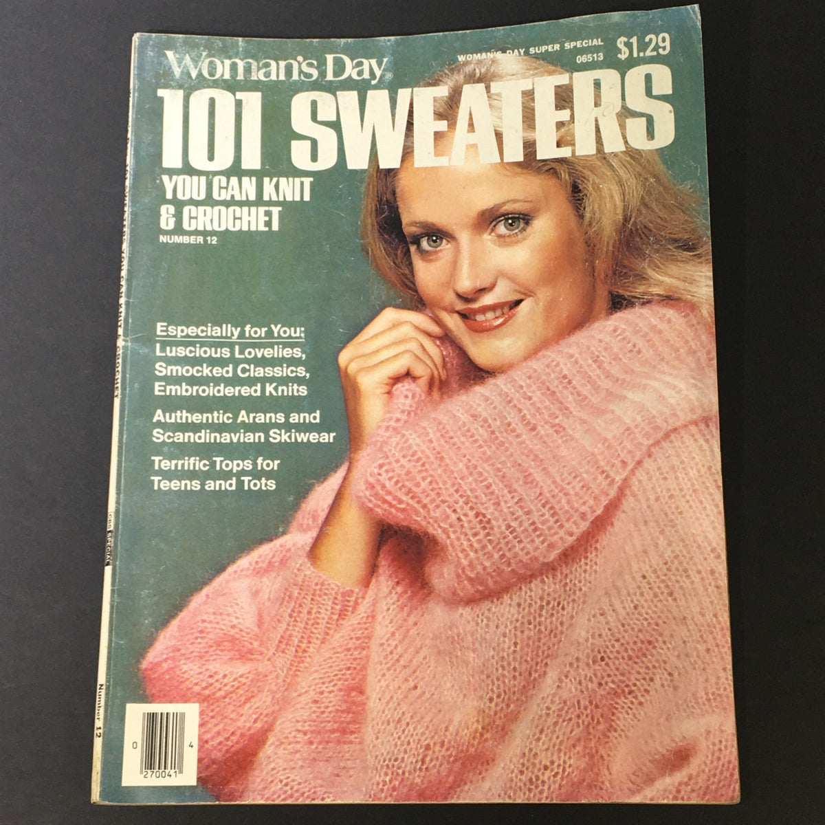 Cover image of VTG Woman's Day 1972 Number 12 showcasing '101 Sweaters You Can Knit & Crochet,' featuring a woman in a pink sweater with a cozy smile.