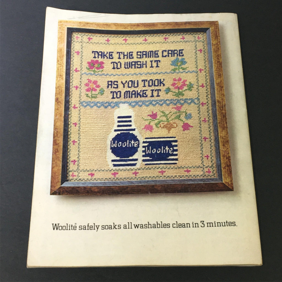 VTG Woman's Day 1972 Number 12 101 Sweaters Knit & Crochet Patterns, Newsstand displaying a vintage advertisement for Woolite laundry detergent featuring a framed cross-stitched design.