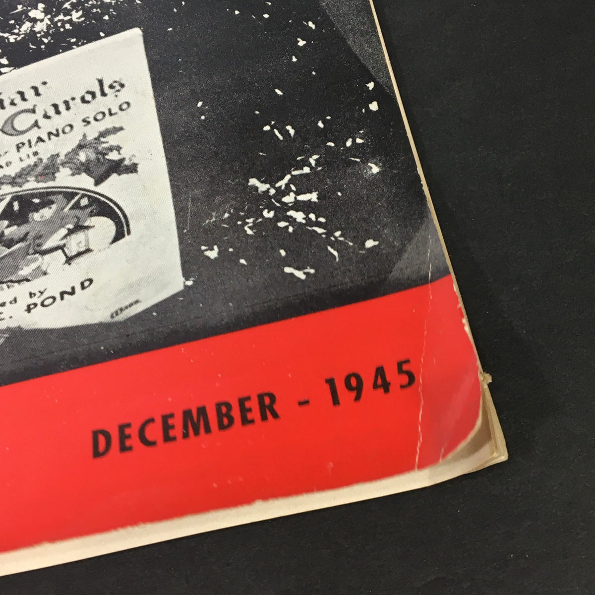 Close-up of December 1945 issue of VTG Home Movies Magazine, highlighting the publication date and festive music theme.