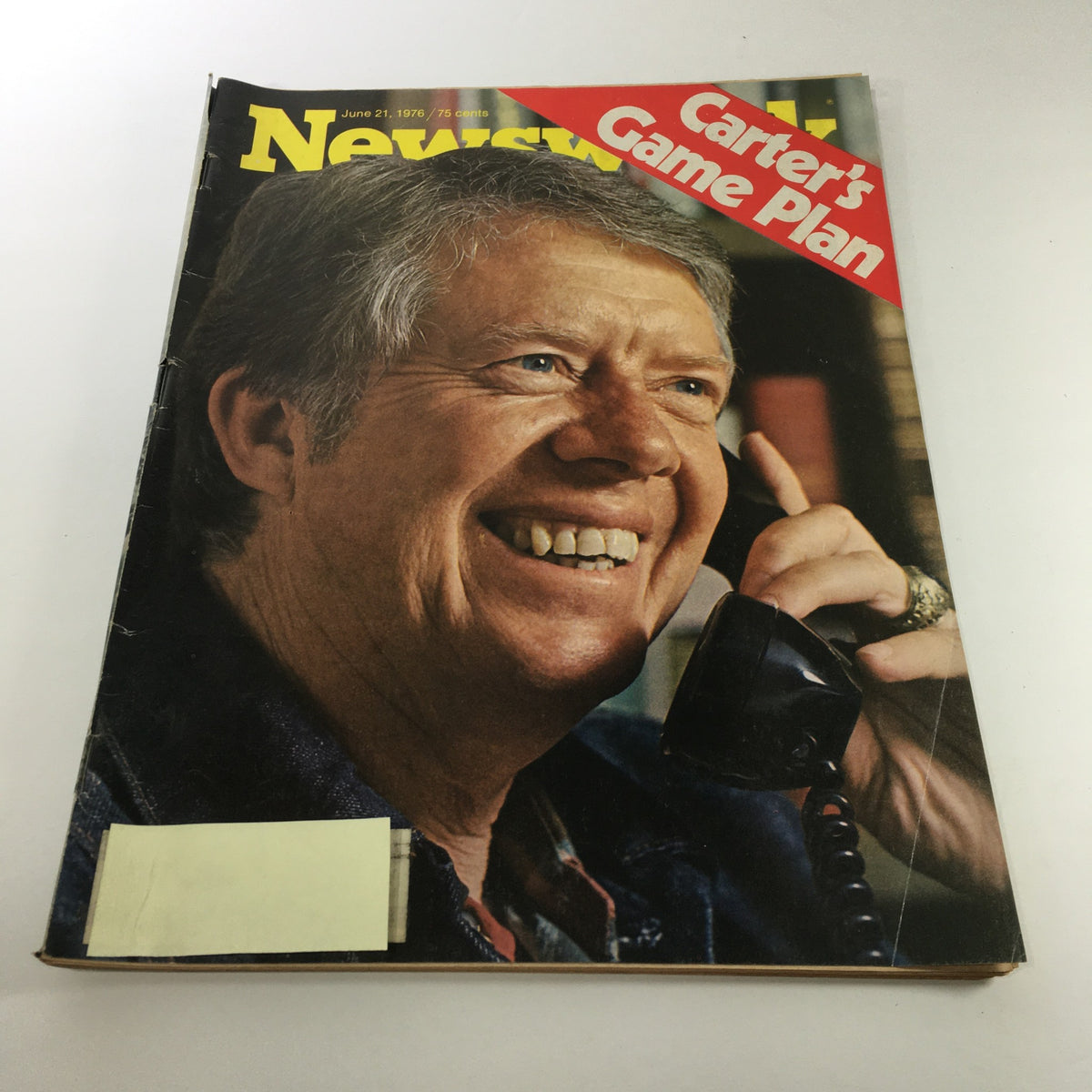 Vintage Newsweek magazine cover from June 21, 1976, featuring the title 'Jimmy Carter's Game Plan.' The image shows a smiling man on the phone, representing the political climate during Jimmy Carter's presidential campaign.