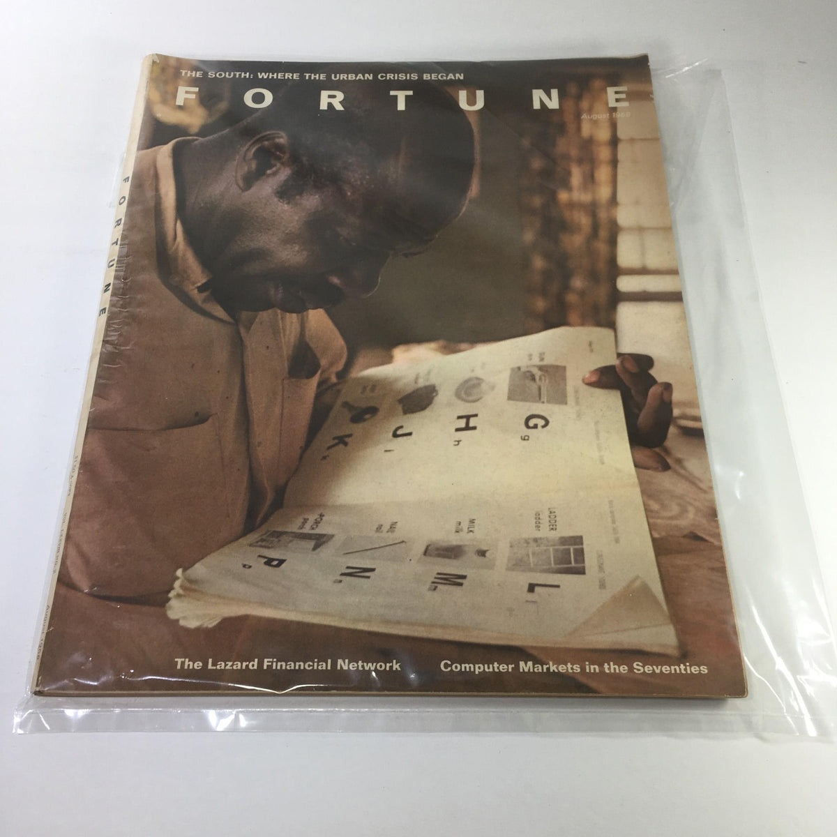 Cover of Fortune Magazine: August 1968 - The South: Where The Urban Crisis Began, featuring a man examining printed pages, highlighting historical and socioeconomic themes.