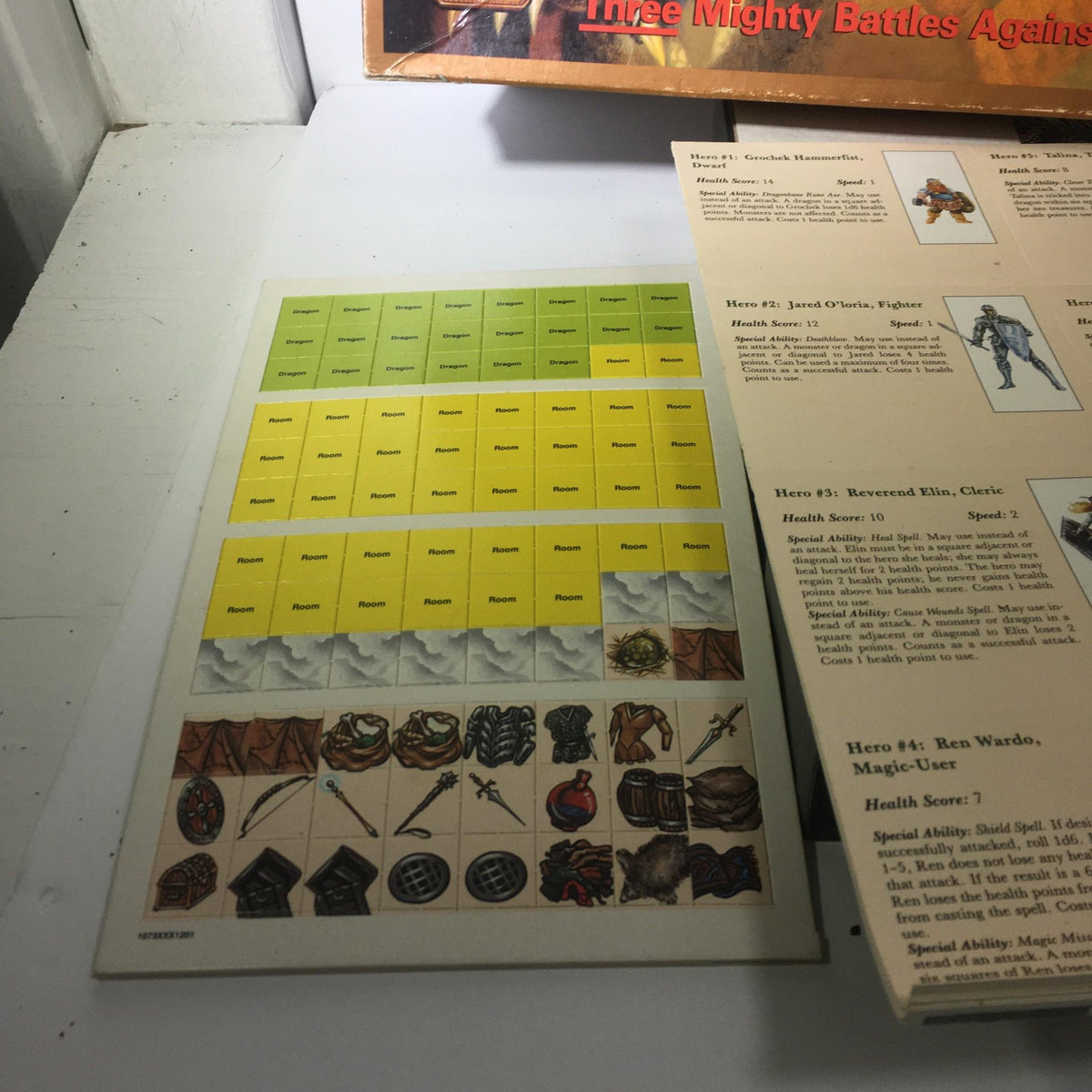 Game components for TSR Board Game: Dungeons & Dragons Game The Dragon's Den, featuring a character health tracker and item graphics.