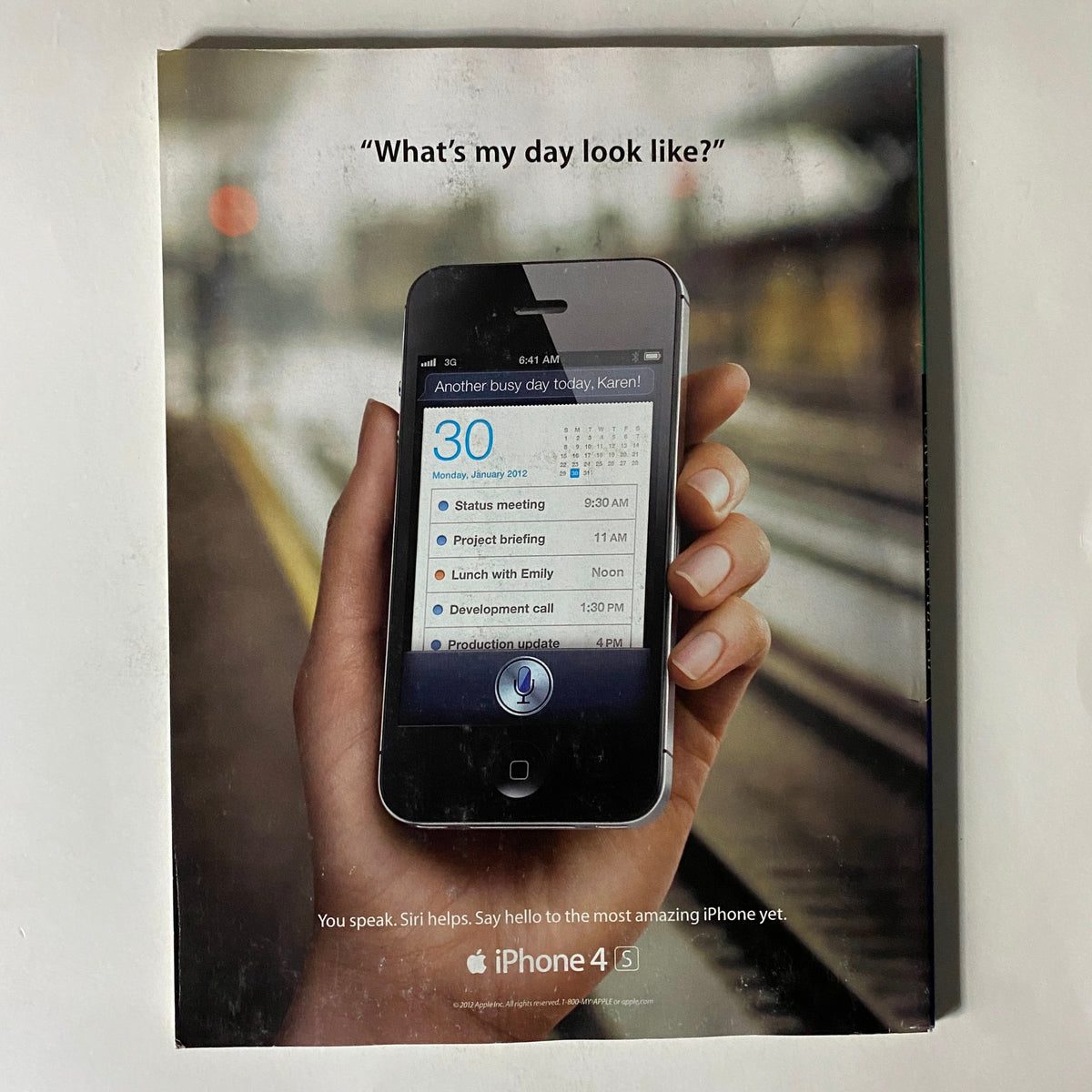 An advertisement from Fortune Magazine's April 30, 2012 issue featuring the iPhone 4S, showcasing its Siri voice assistant functionality with the slogan 'What's my day look like?'.