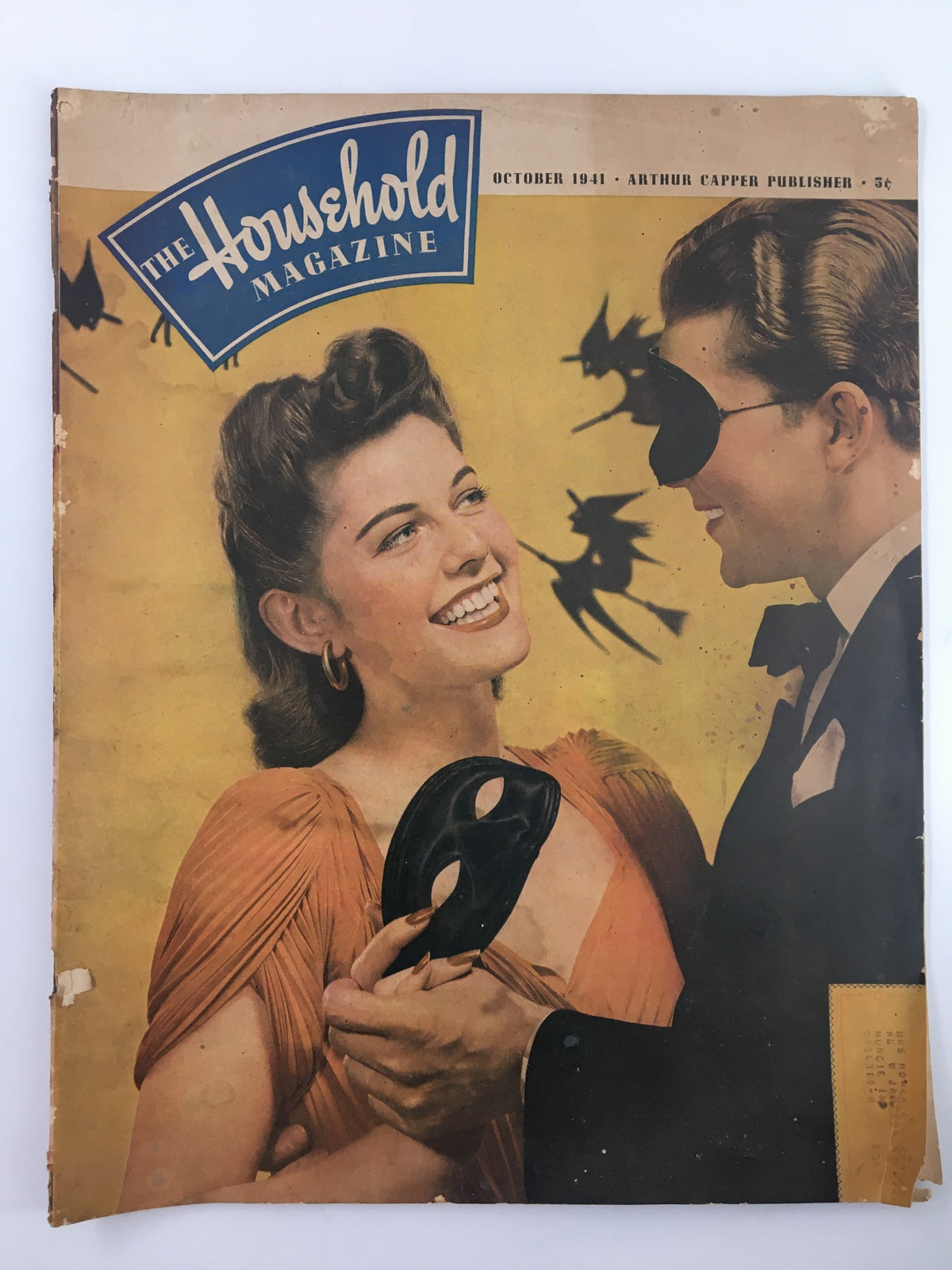 Cover of the vintage October 1941 issue of The Household Magazine, featuring a woman with a mask and a man in a tuxedo, showcasing the theme 'Young People Are So Resourceful'.