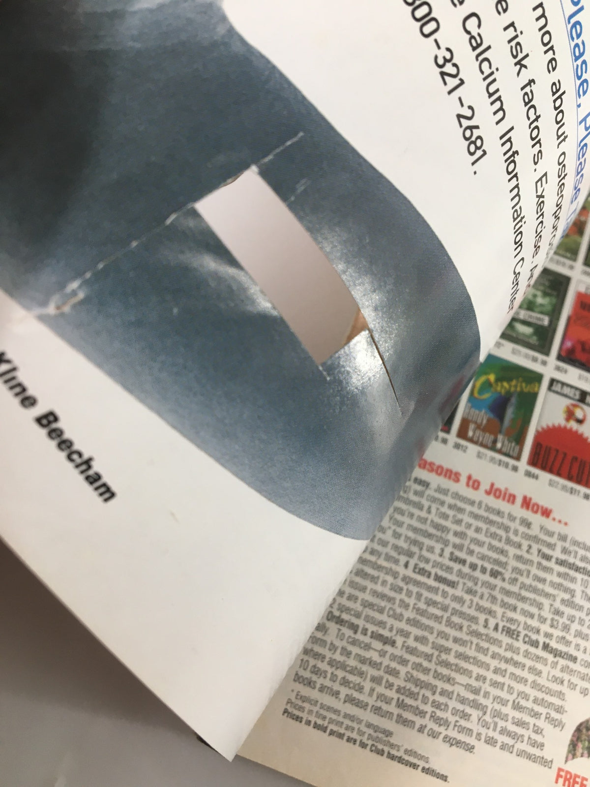 Close-up of The Saturday Evening Post March 1997 magazine showing a cutout and additional page details.