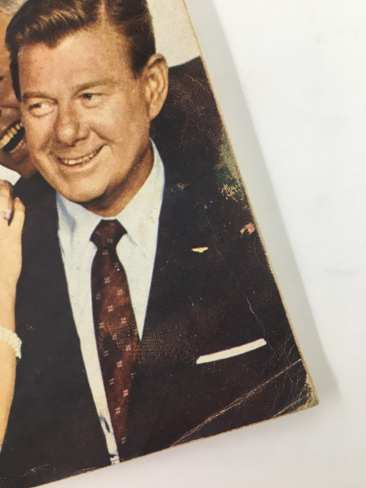 Close-up of a smiling man in a suit from TV Guide Magazine February 25, 1961, highlighting the era's style and culture of television personalities.