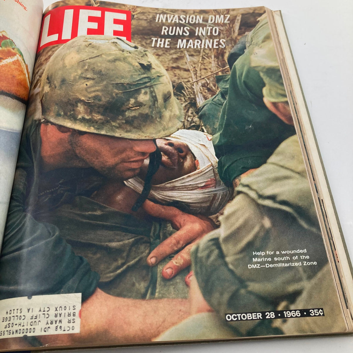 Cover of the VTG 1966 Bound Life Magazine depicting a marine aiding a wounded soldier in a scene related to the article 'Invasion DMZ Runs Into The Marines' dated October 28, 1966.
