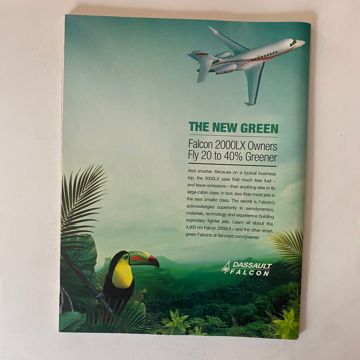 Back cover page of Fortune Magazine April 12, 2010, showcasing an advertisement for Falcon 2000LX aircraft, promoting greener flying options with a vibrant image of a toucan in a tropical setting.