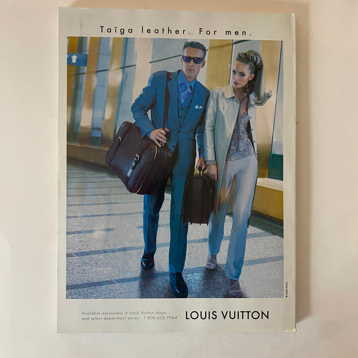 Louis Vuitton advertisement featuring a stylish man and woman modeling Taiga leather products, featured in Fortune Magazine October 27, 1997.