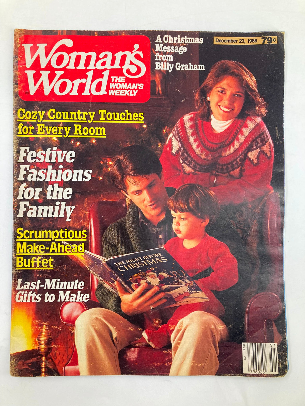 Cover of Woman's World Magazine December 23 1986 featuring a Christmas message from Billy Graham, cozy family scene with festive decorations. Highlights include 'Cozy Country Touches for Every Room' and 'Scrumptious Make-Ahead Buffet'.
