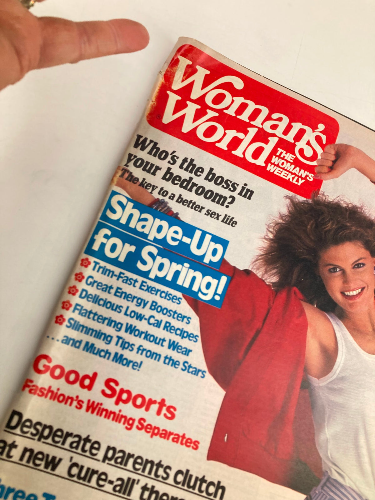 Close-up of the Woman's World Magazine January 14 1986 cover highlighting sections on fitness and relationships, featuring a model smiling while wearing a white top and red cardigan.