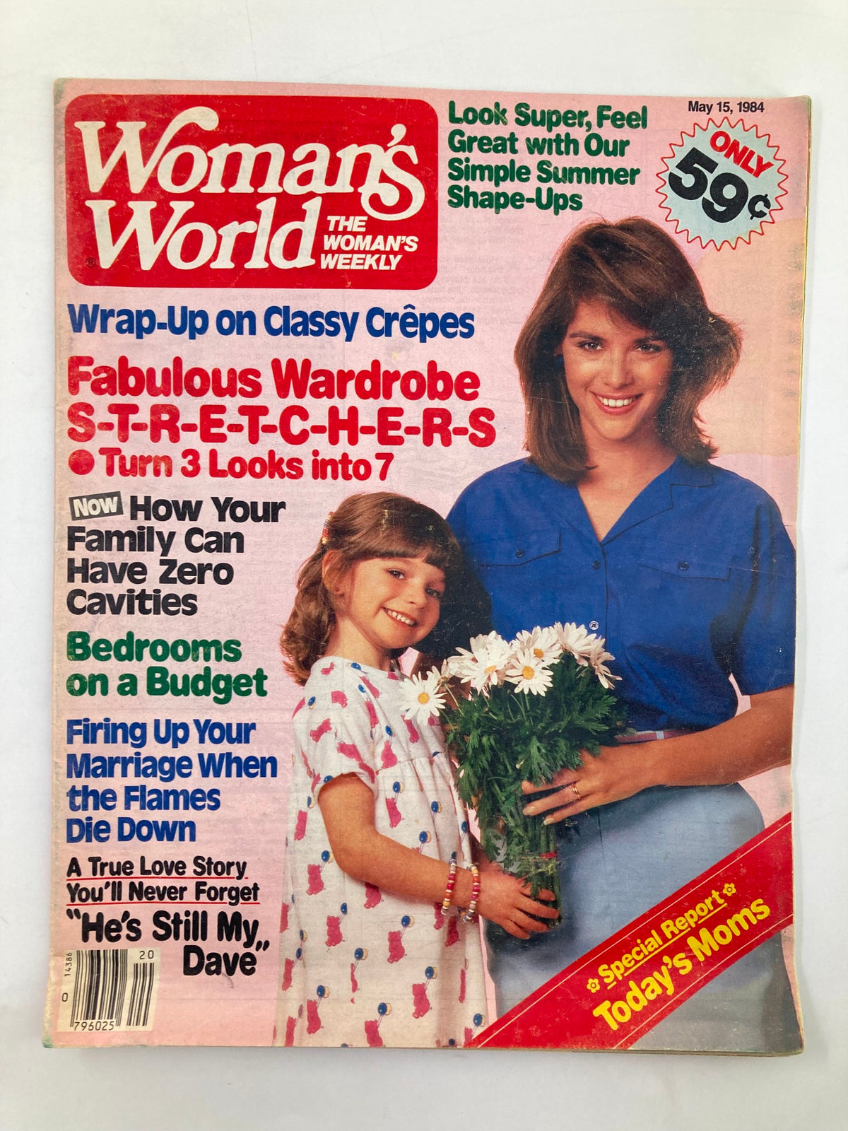 Cover of Woman's World Magazine May 18 1984 featuring a woman and a girl holding flowers, highlighting articles on fashion, home budgeting, and marriage tips.