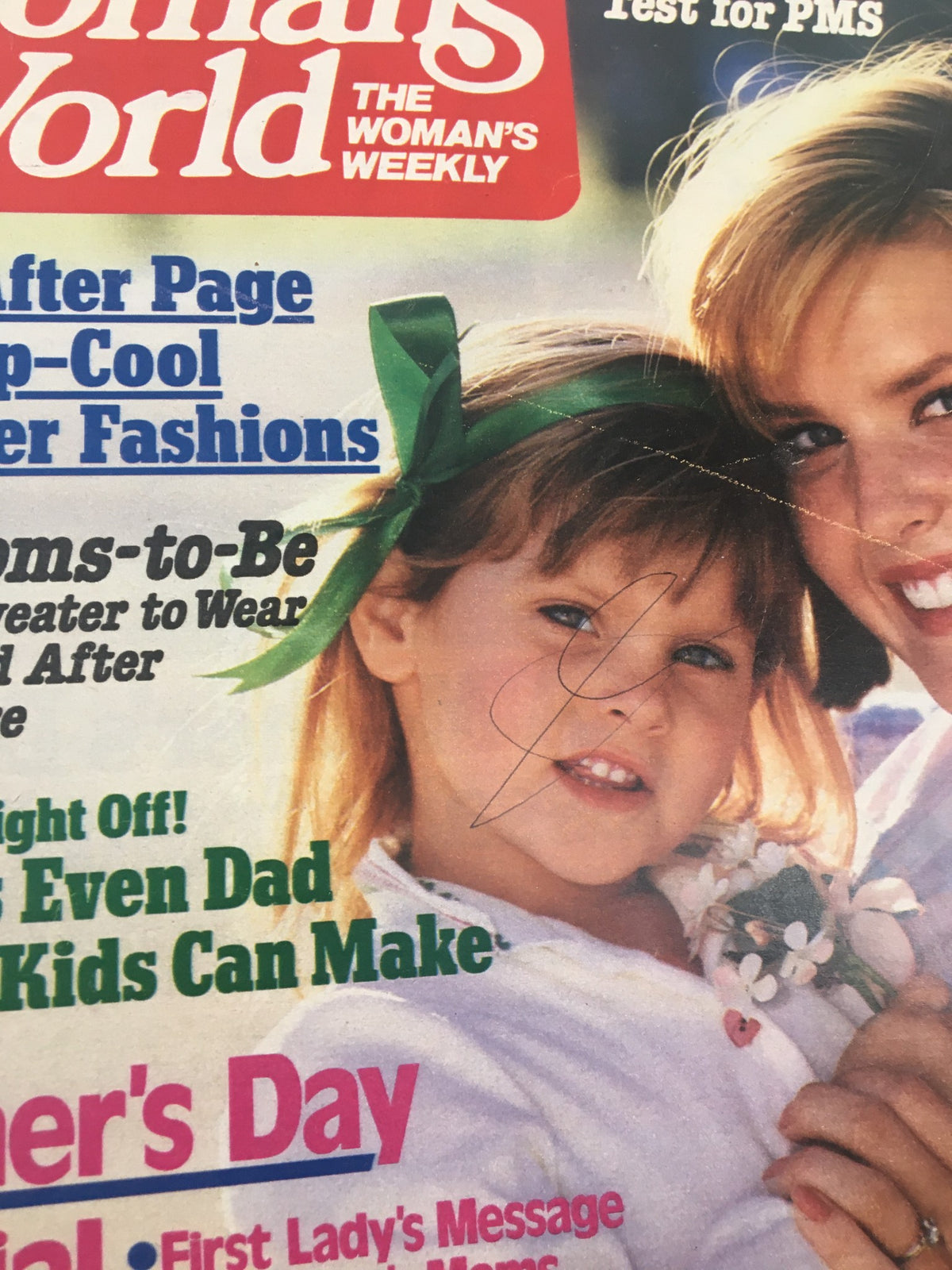 Close-up of the cover of Woman's World Magazine May 7, 1985, highlighting a young girl with a green ribbon and a flower bouquet alongside her mother, emphasizing 'A Daughter's Tender Tribute.'