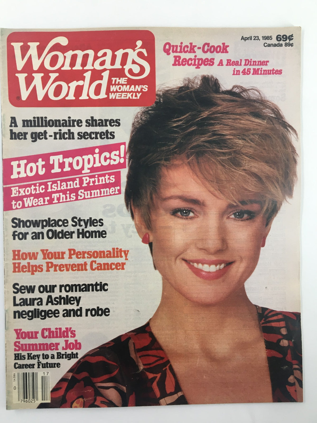 Woman's World Magazine cover from April 23, 1985 featuring an article on Laura Ashley negligee and robe, showcasing a smiling woman with short hair and vibrant background. Highlights include quick-cook recipes, summer job tips, and health insights.