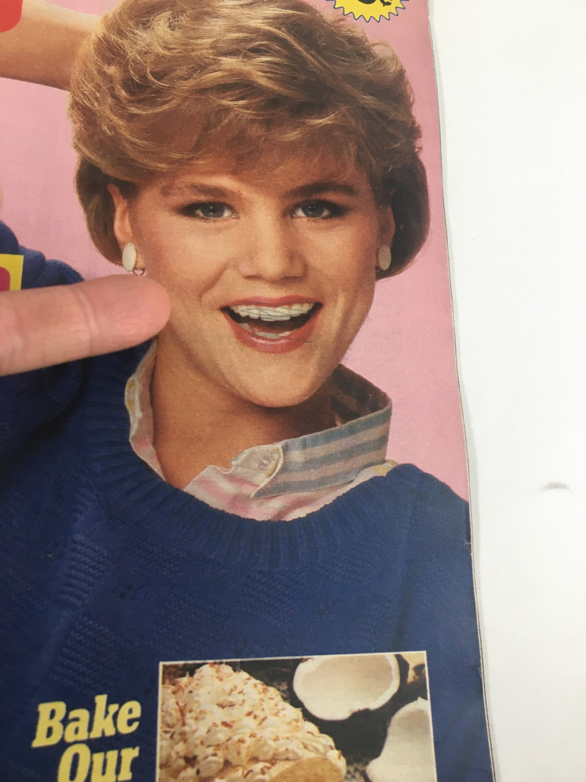 Close-up of the smiling woman on the cover of Woman's World Magazine June 3 1986, showcasing her blue sweater and cheerful expression.