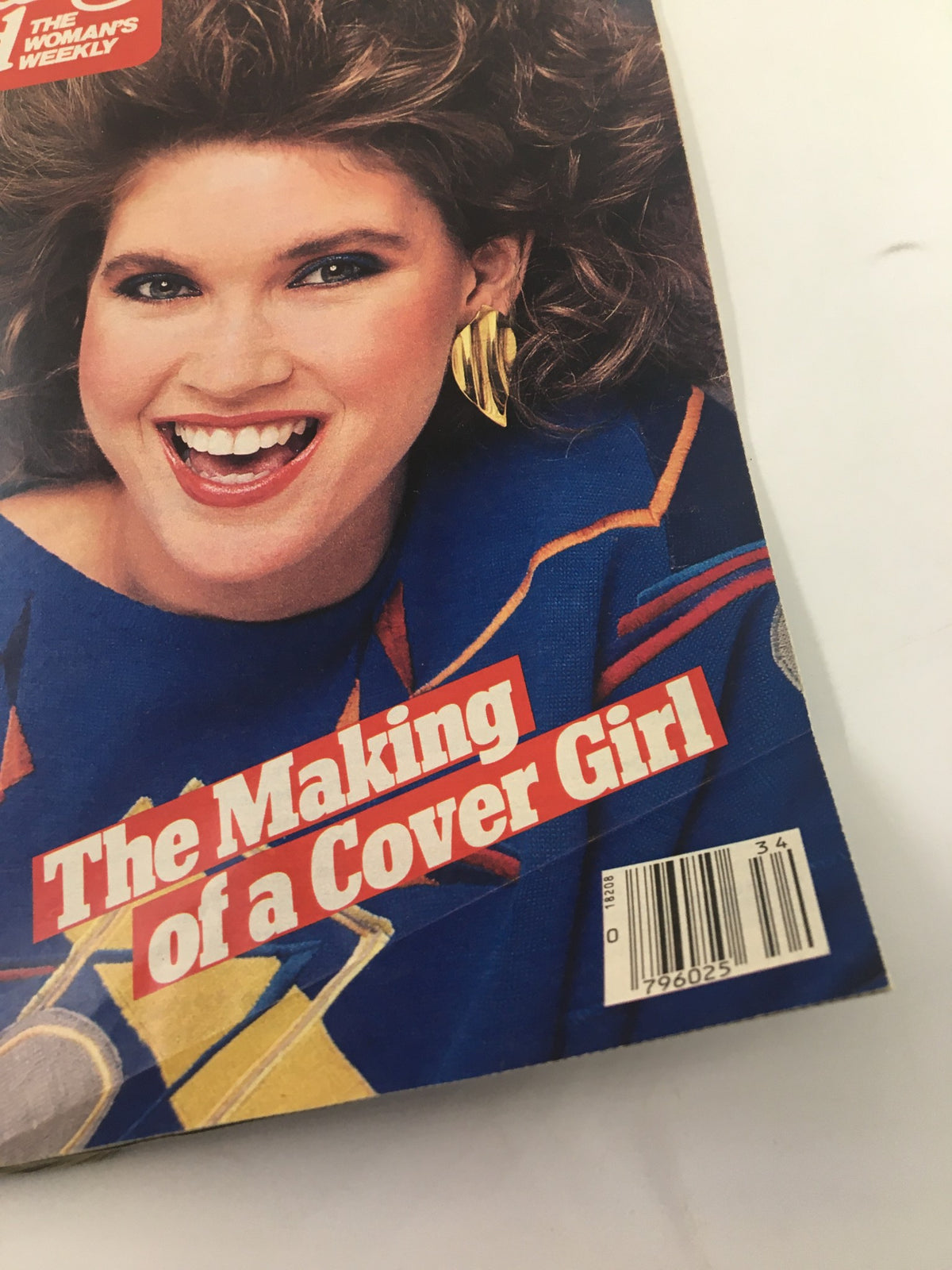 Close-up of Woman's World Magazine cover dated August 26, 1986, highlighting the article 'The Making of a Cover Girl' with a joyful model wearing distinct 80s accessories.