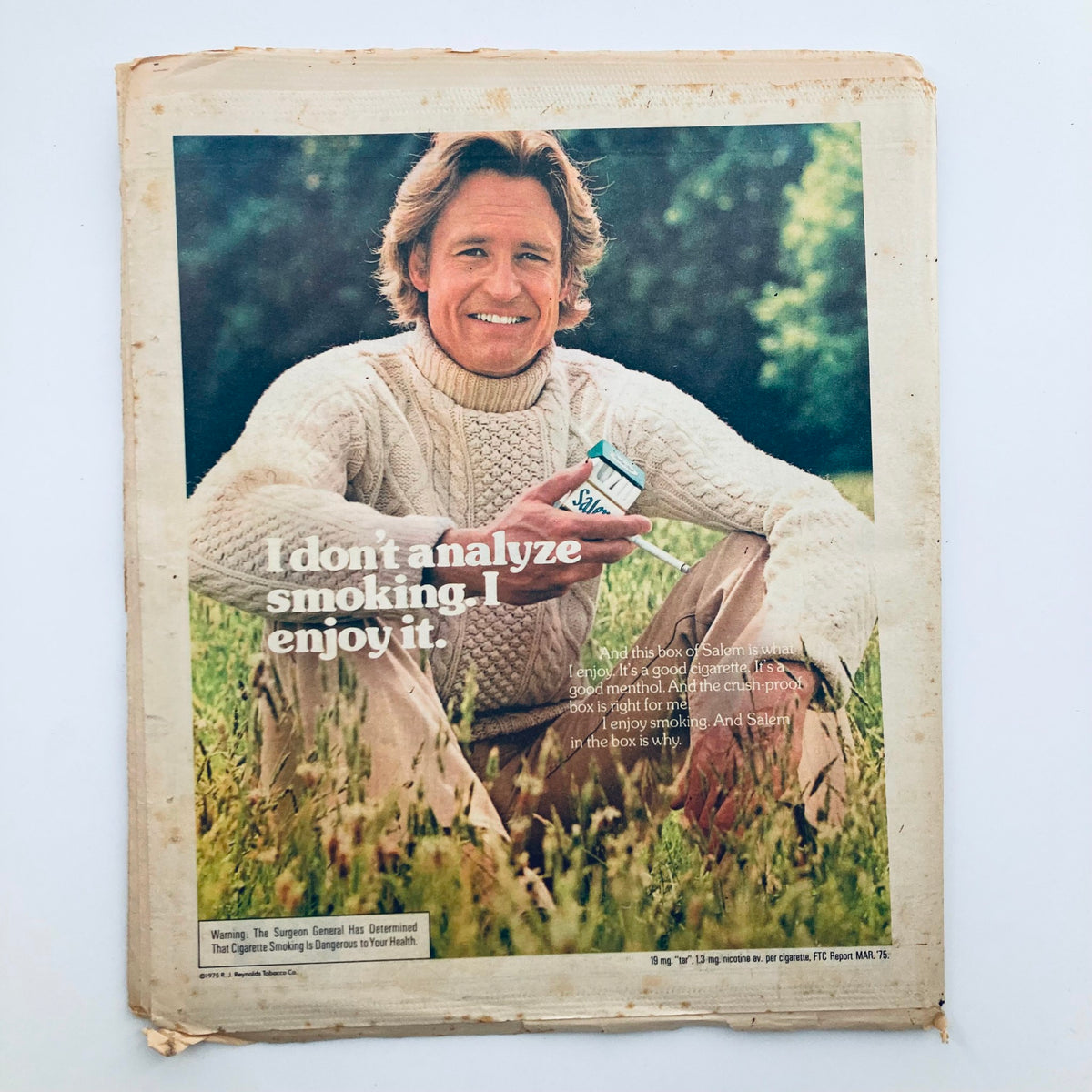 Back cover of the Rolling Stone Magazine, December 18, 1975, displaying an advertisement with a man in a sweater enjoying Salem cigarettes, associated with the iconic issue No. 202.