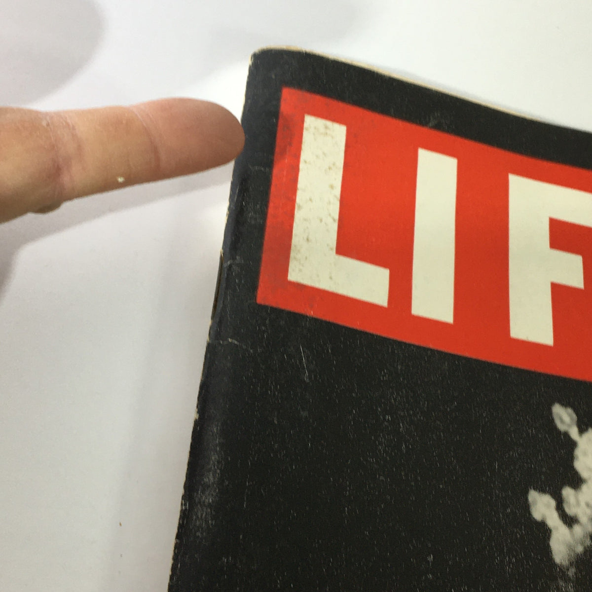 Close-up of the spine of VTG Life Magazine, February 18, 1952, showing the recognizable red and white title 'LIFE'. This image highlights the logo and minor wear consistent with its vintage status.
