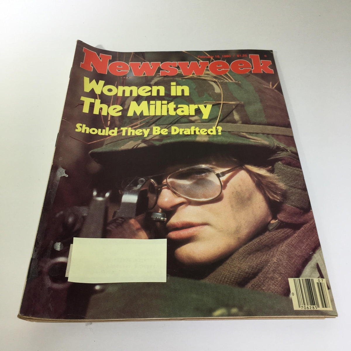 Vintage Newsweek Magazine from February 18, 1980, featuring the title 'Women in The Military: Should They Be Drafted?'. The cover depicts a close-up of a young woman in military attire, emphasizing the discussion on women's roles in armed forces during a significant period in history.