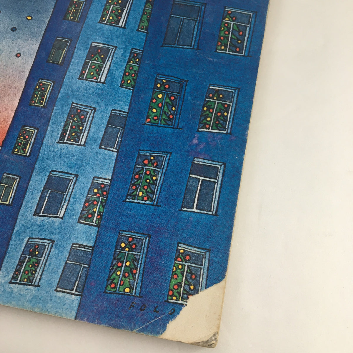 Close-up of the cover of The New Yorker Magazine December 17, 1973 by Jean-Michel Folon, highlighting the colorful windows adorned with holiday lights.