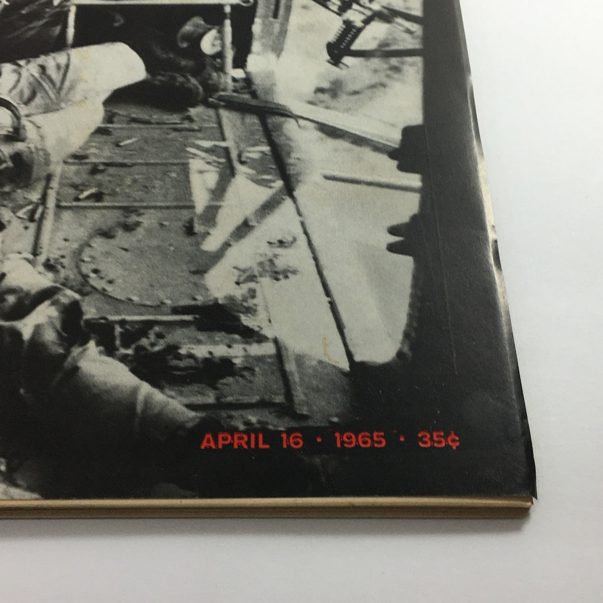 Detail of vintage Life Magazine from April 16, 1965, featuring the Vietnam flight crew cover story. The image shows a close-up of the magazine's spine and date.