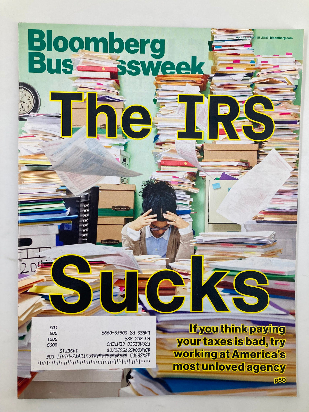 Bloomberg Businessweek Magazine cover from April 13, 2015, featuring the headline 'The IRS Sucks.' The image showcases a distressed individual surrounded by piles of paperwork, representing the challenges of working with America’s most unloved agency.