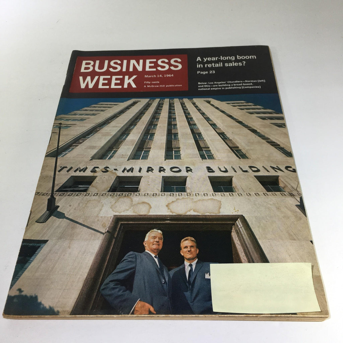 Cover of Business Week Magazine dated March 14, 1964, featuring a photo of two men in front of the Times-Mirror Building in Los Angeles, highlighting the influence of the Chandler brothers, Norman and Otis. The magazine addresses a year-long boom in retail sales.