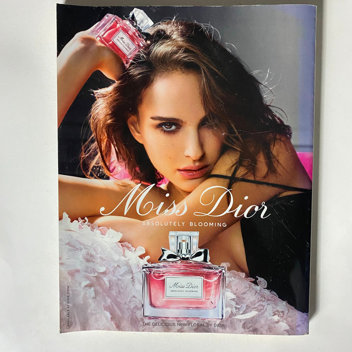 Advertisement for Miss Dior perfume in Vogue UK Magazine October 2016, showcasing the fragrance bottle with a glamorous model highlighting the product.
