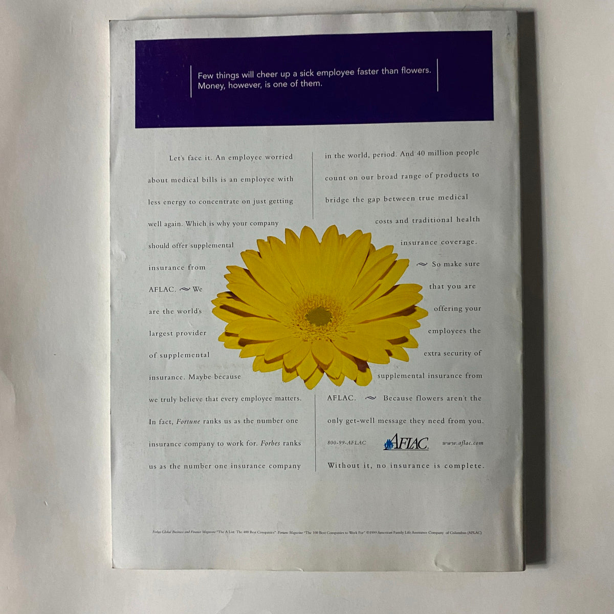 Back cover of Fortune Magazine July 19, 1999, featuring an advertisement for AFLAC with a large yellow flower and text about supplemental insurance.