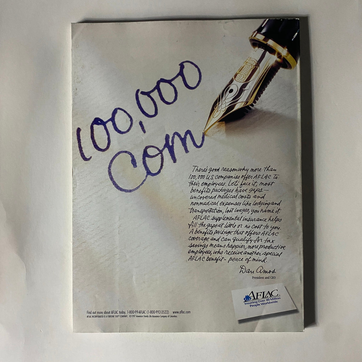 Back cover of Fortune Magazine June 23, 1997, featuring a pen over a handwritten note stating '100,000 Com', with text discussing Aflac's benefits packages for employers.