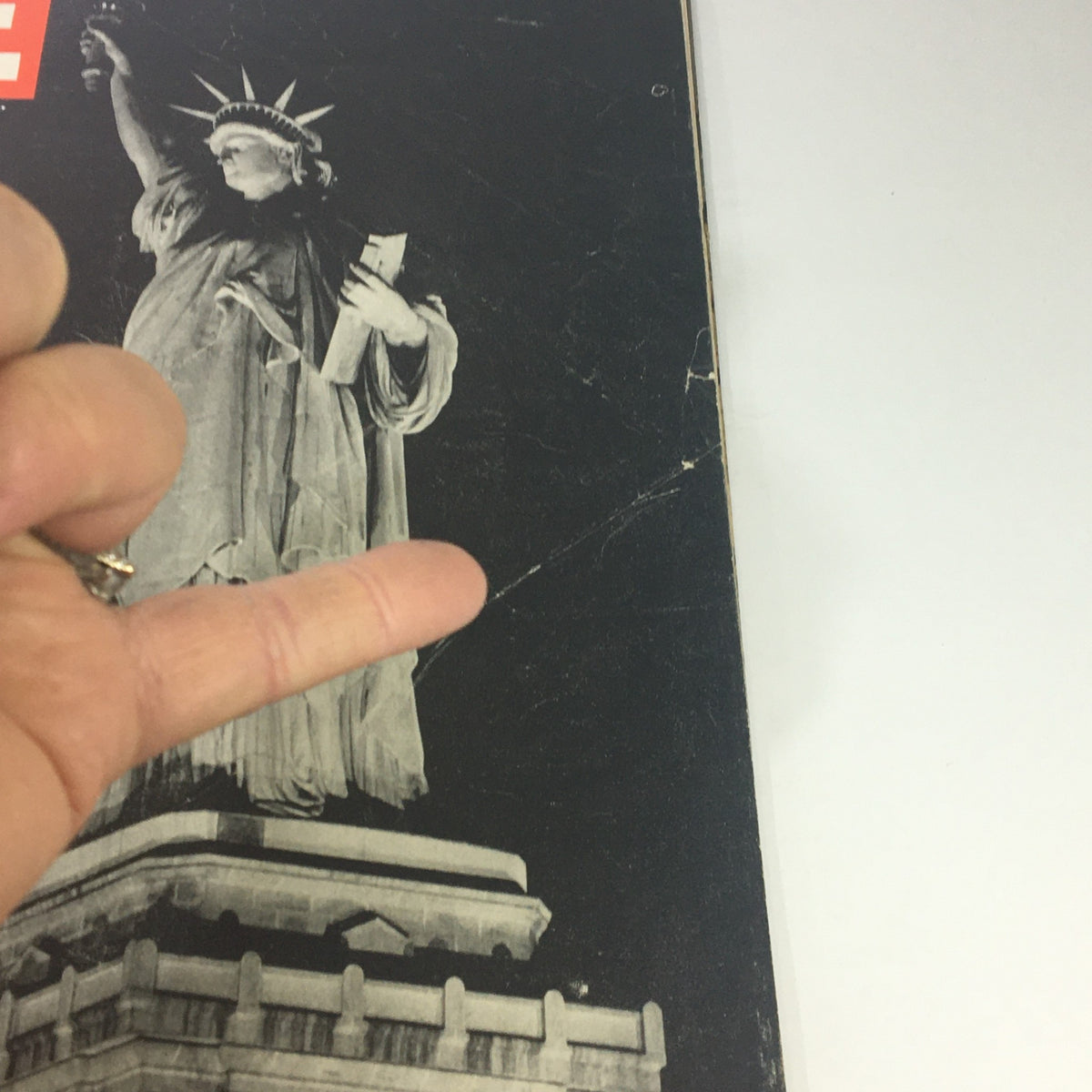 Close-up of the Statue of Liberty on the cover of VTG Life Magazine June 26 1944 with a finger gesture pointing at the statue.