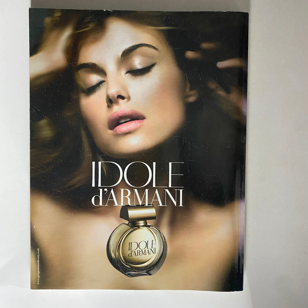 Ad for Idole d'Armani featured in Vogue UK Magazine November 2009, displaying a glamorous model with an emphasis on luxury fragrance.