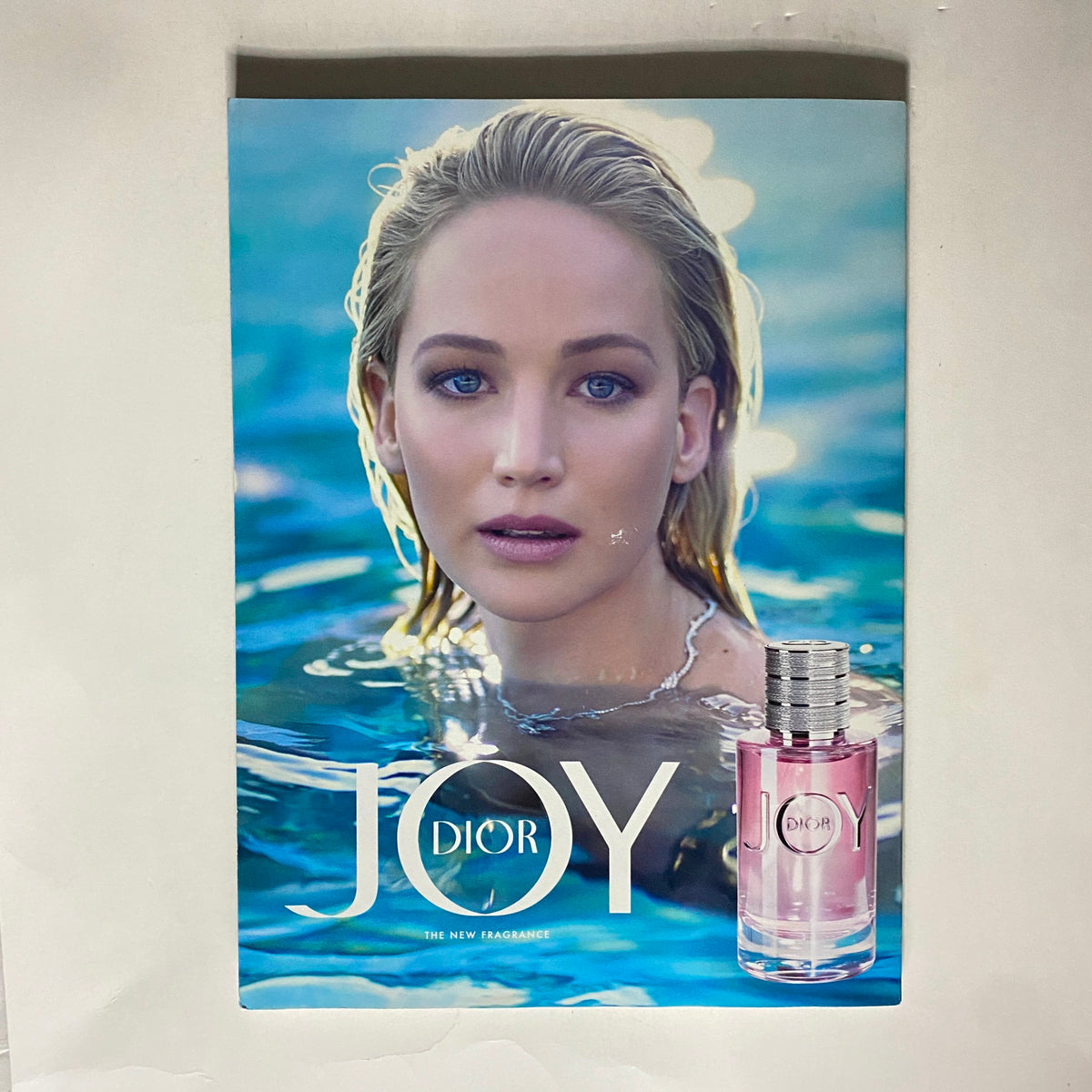 Vogue Magazine October 2018 cover featuring Dior's fragrance 'JOY' with Jennifer Lawrence, highlighting fashion advertising aesthetics and trends reflective of Lady Gaga's impact on the fashion industry.