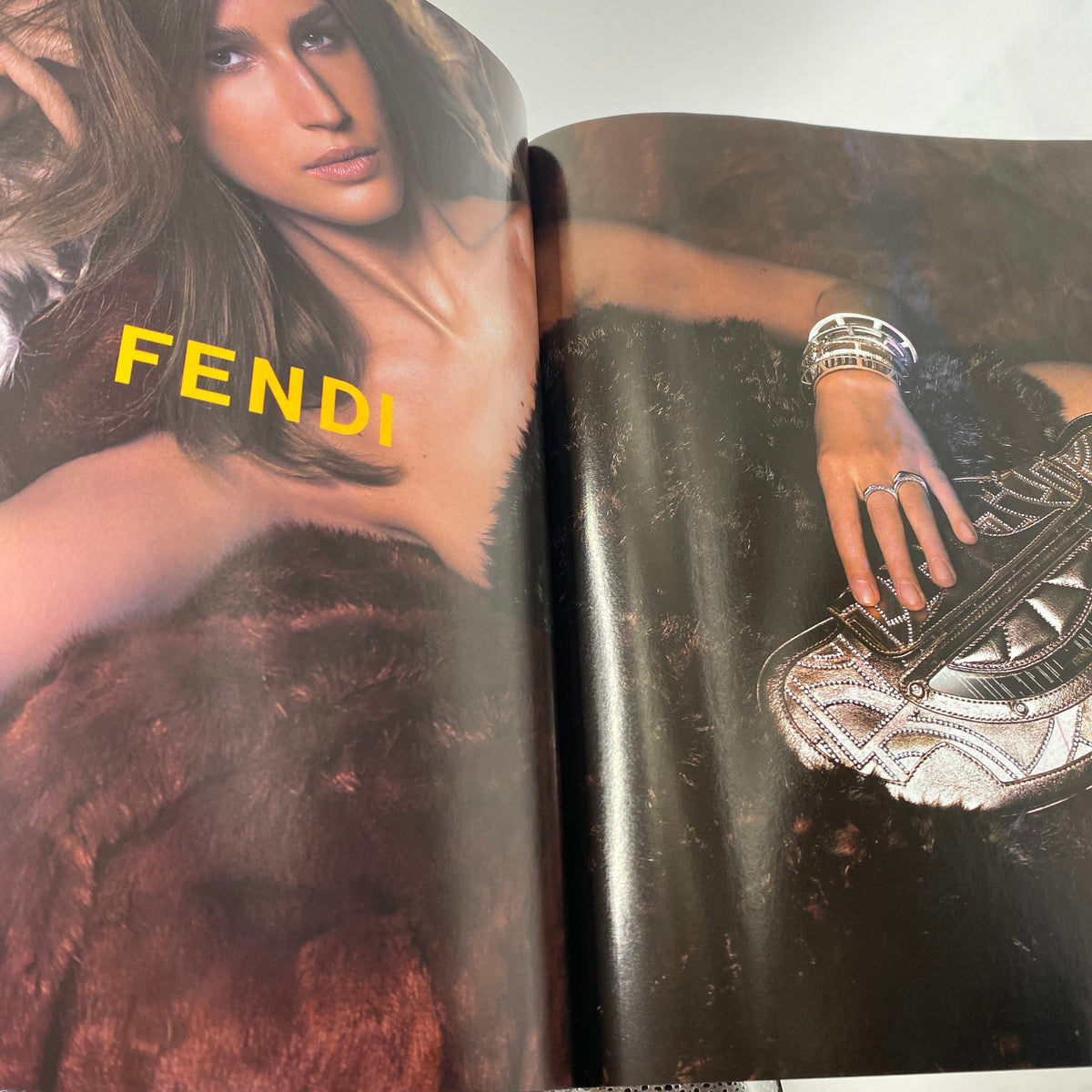 Fendi advertisement featured in Vogue Magazine August 2004, displaying high-fashion accessories on a model.