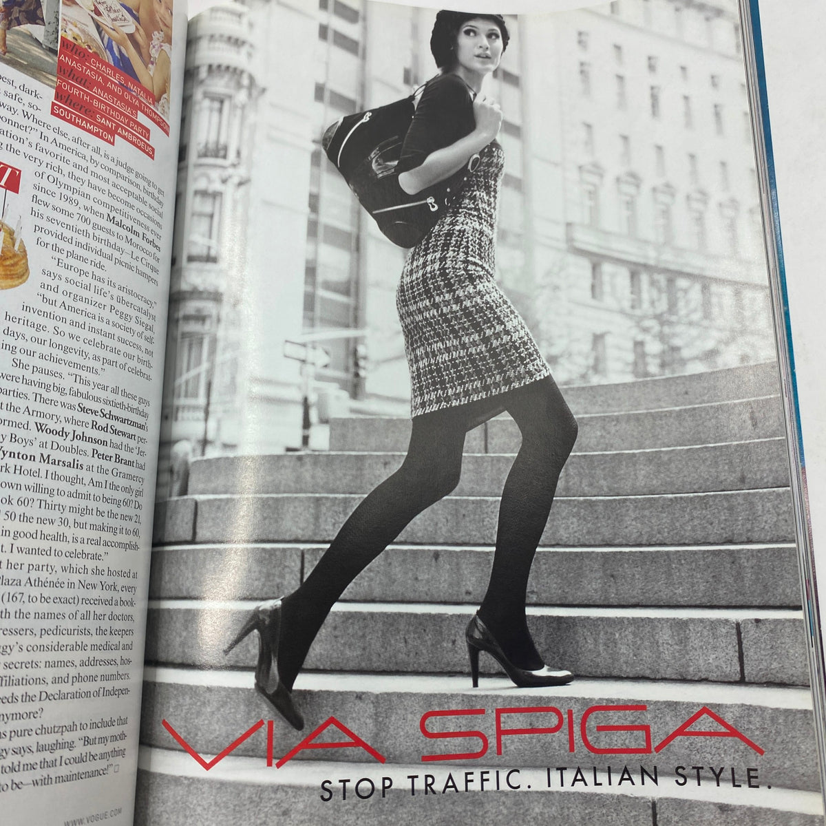 Vogue Magazine October 2007 Cover showcasing a model in a black and white advertisement for Via Spiga, highlighting Italian style with stylish attire and high heels.