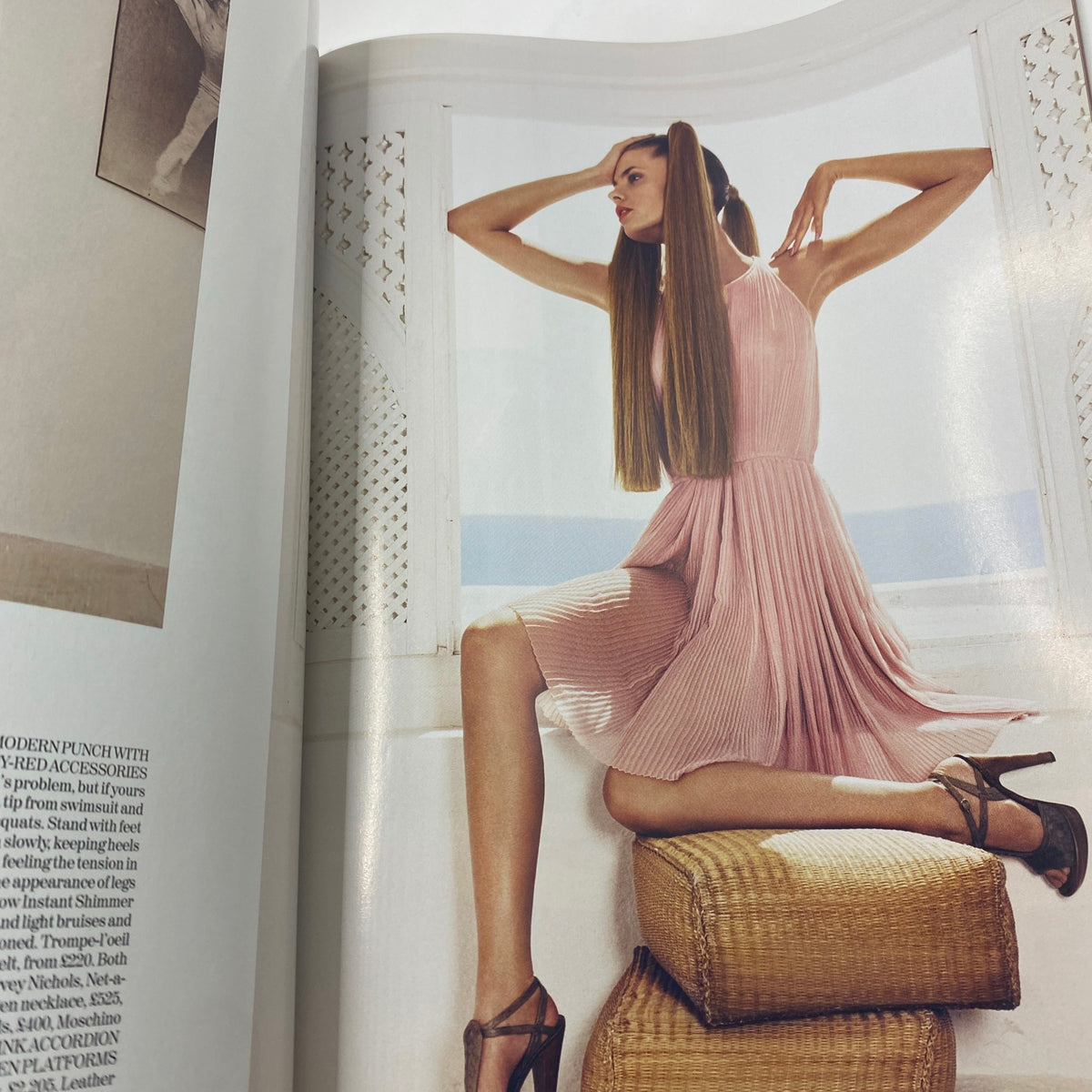 Stylish editorial photograph from Vogue UK Magazine June 2007, depicting a model in a chic pleated dress, representing fashion trends of the early 2000s.