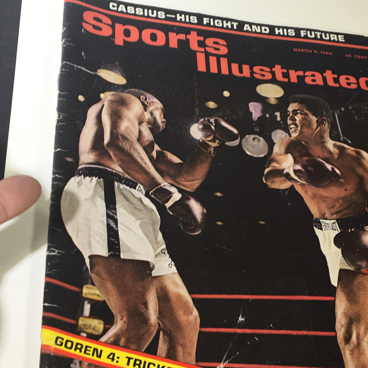 Close-up of the cover of Sports Illustrated Magazine March 9 1954 showcasing Muhammad Ali and Cassius Clay, reflecting the 1950s boxing culture.