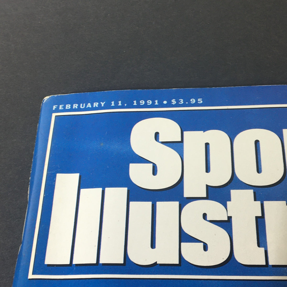 Close-up of the Sports Illustrated Magazine February 11, 1991 displaying the title and date, highlighting its collectible nature.