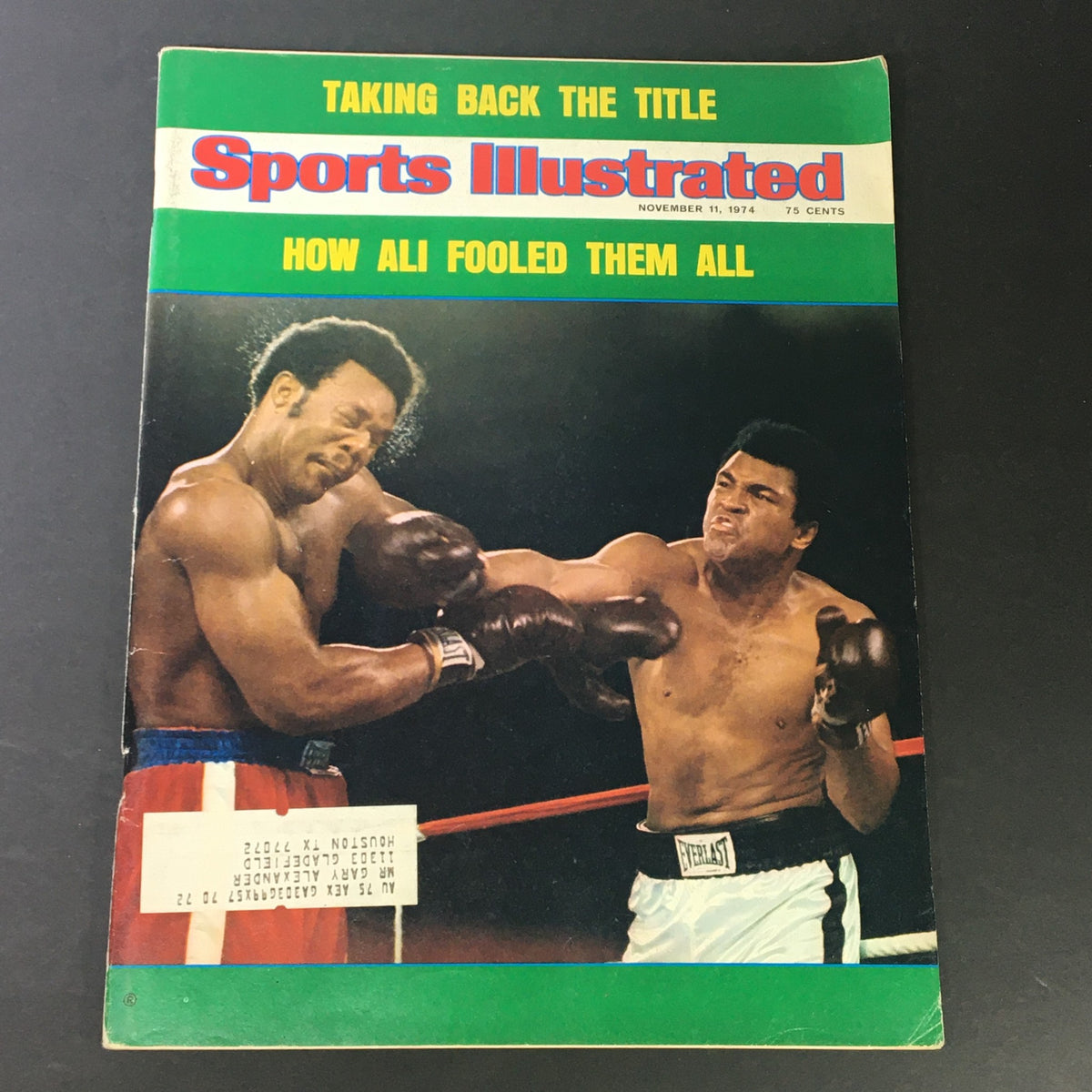 Vintage Sports Illustrated Magazine from November 11, 1974, featuring Muhammad Ali vs. George Foreman on the cover, showcasing a historic boxing match.